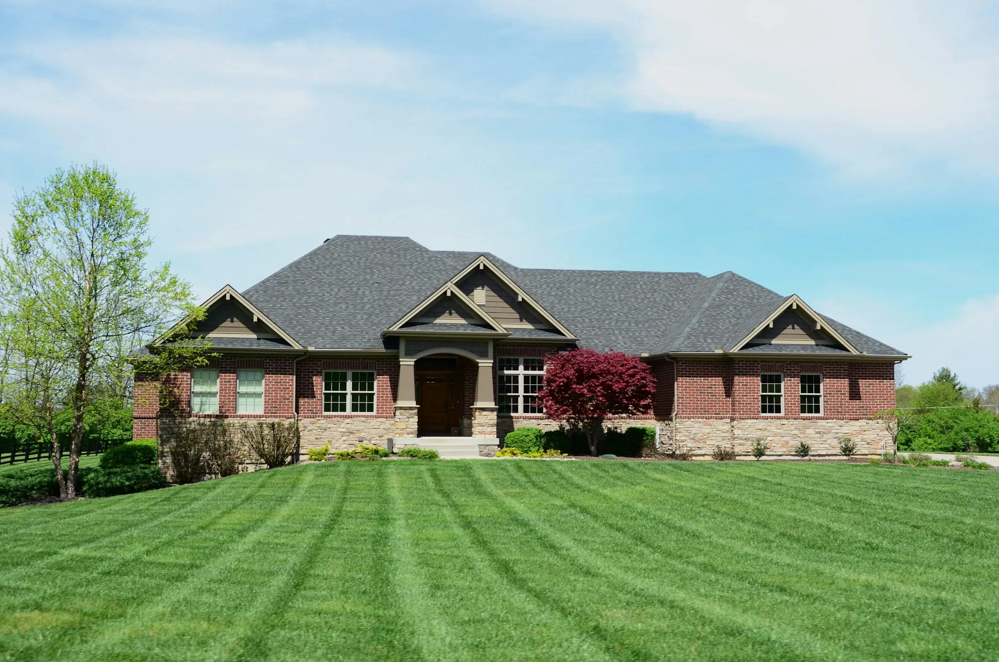 Brick ranch home with a wide mowed lawn